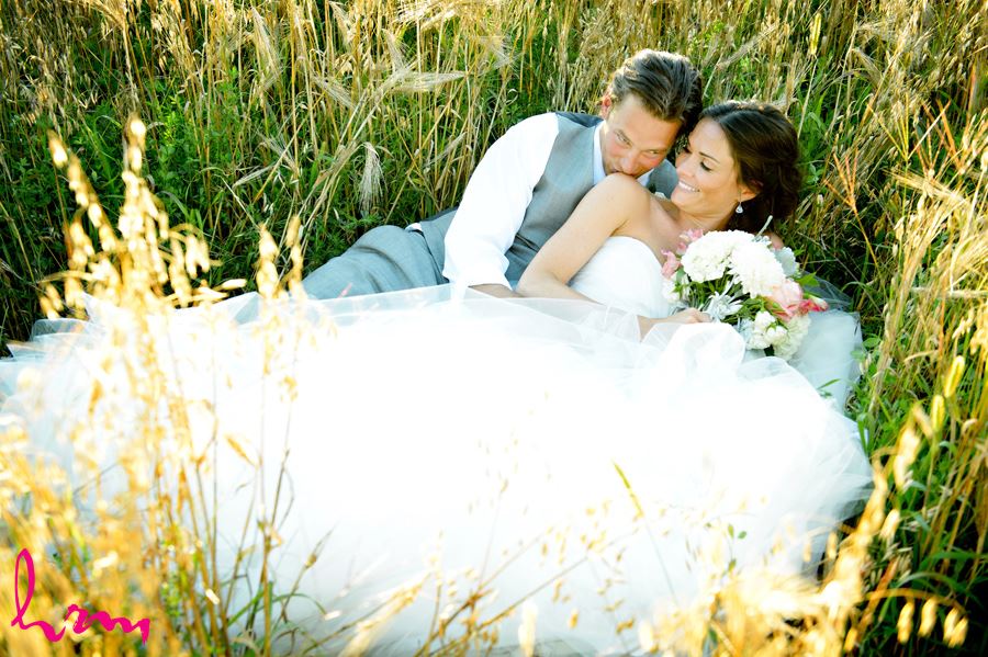 Leigh and Pete in laying in field Purple Hill Country Farms London ON Wedding Photography