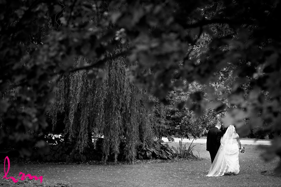 Mallory and Will walk in trees St. Thomas ON Wedding Photography