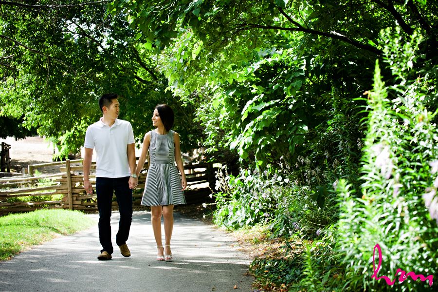 Couple walking through forest holding hands