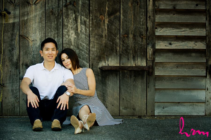 couple sitting in front of wooden background