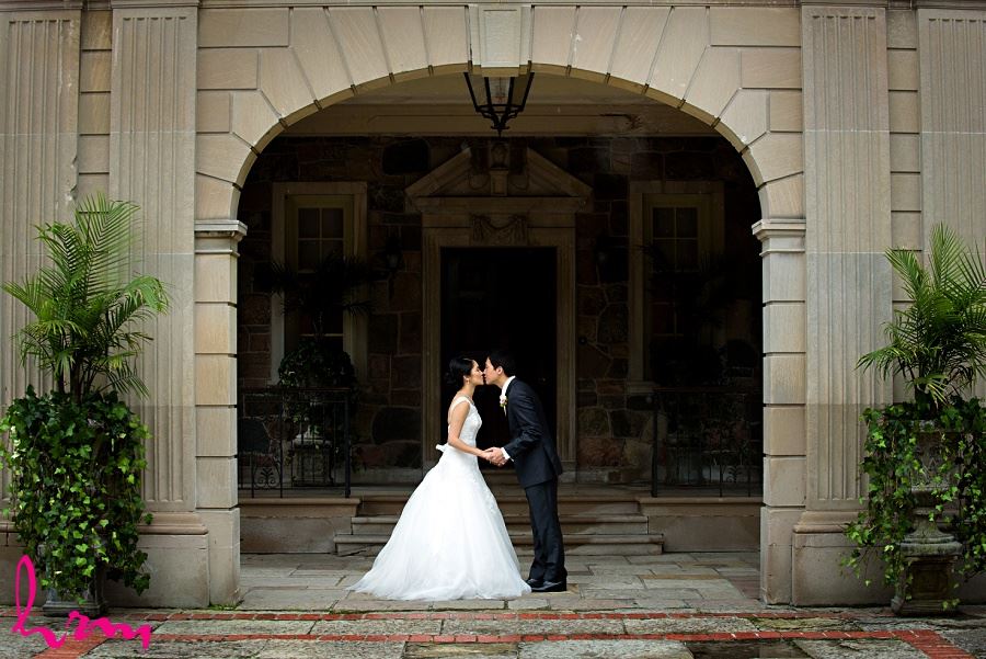 Natalie + Michael kiss outside Graydon Hall Manor Toronto ON Wedding Photography