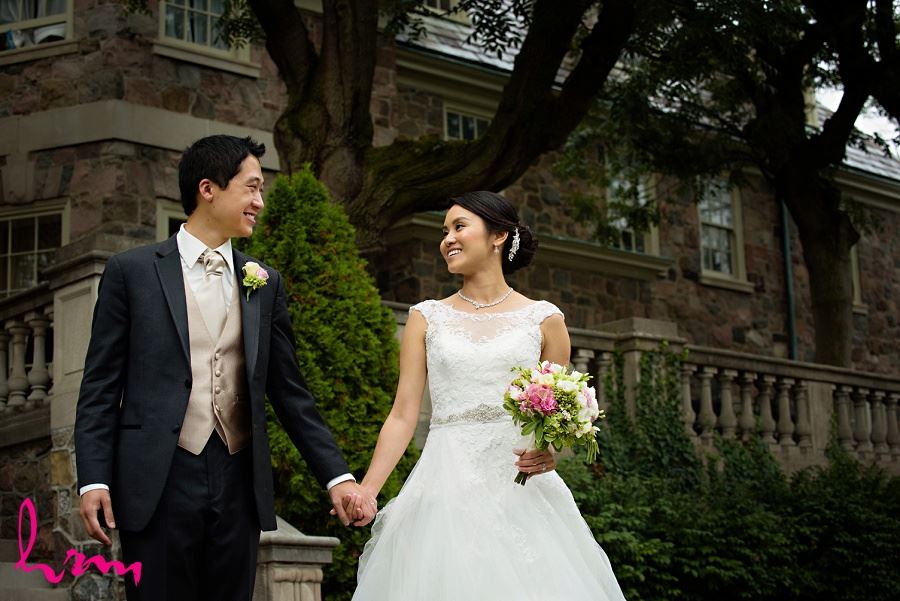 Natalie and Michael by stone buildings at Graydon Hall Manor Toronto ON Wedding HRM Photography