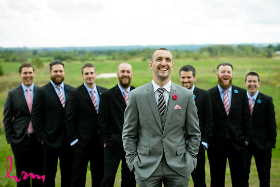 Groomsmen in black pink and blue with striped ties