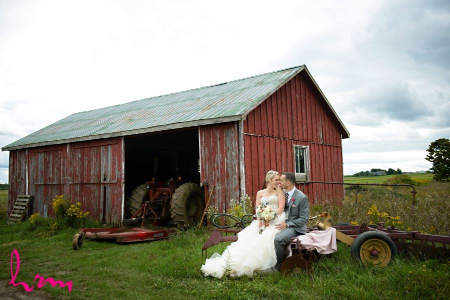 Bride and groom in front of old red barn farm wedding 