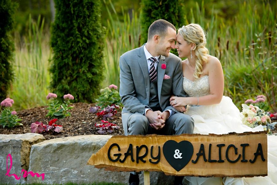 Bride and groom with personalized wooden sign