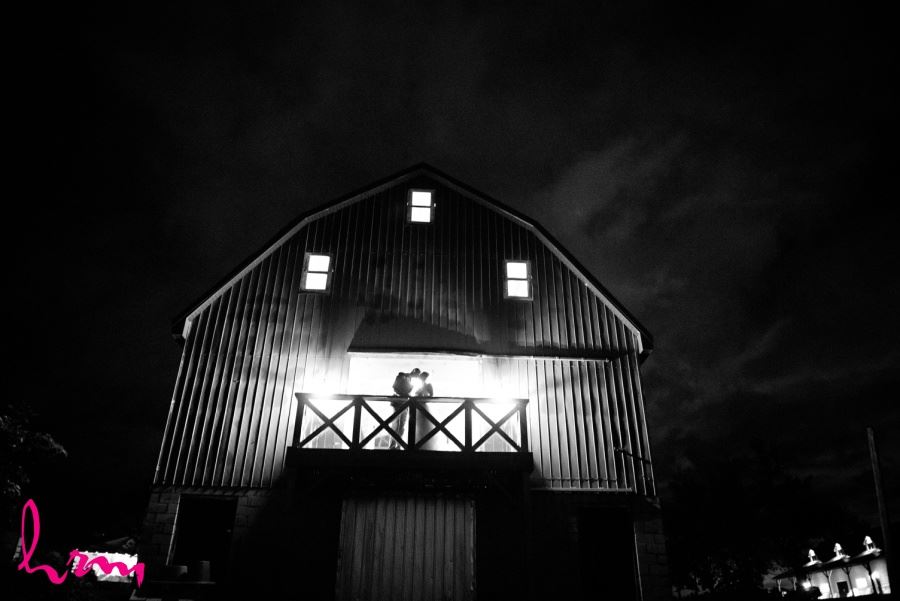 Bride and Groom in front of barn nighttime kissing shot