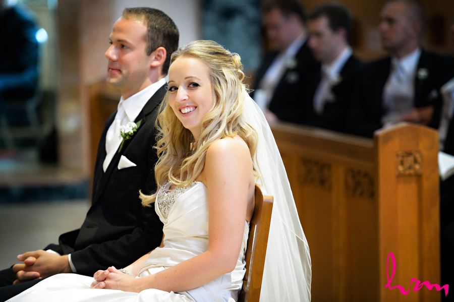 Bride smiling at the end of the alter