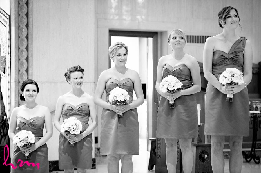 Black and white photo of bridesmaids while watching the bride and groom exchanging vows in London Ontario