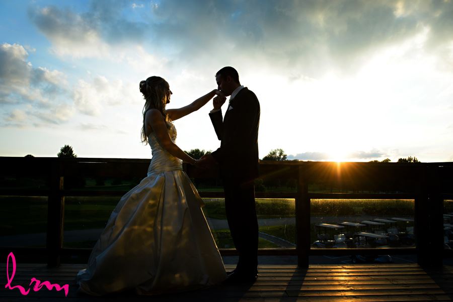 Groom kissing bride at sunset at West Haven Golf