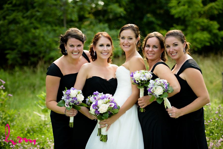 wedding bridal party black dresses purple bouquets